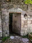 door ajar in a stone wall